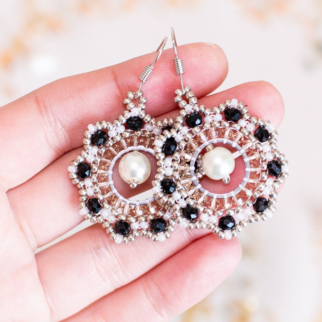 a pair of earrings sitting on top of a table